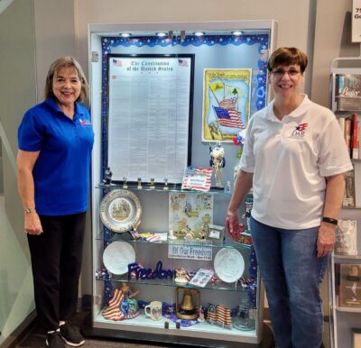 two women with Constitution Week display