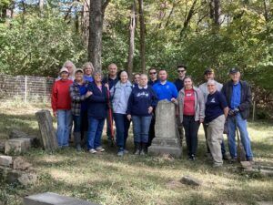 group of people surround cemetery area they recently cleaned up