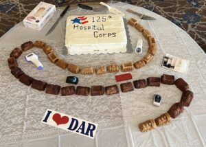 cake surrounded by medical supplies and small train with many cars