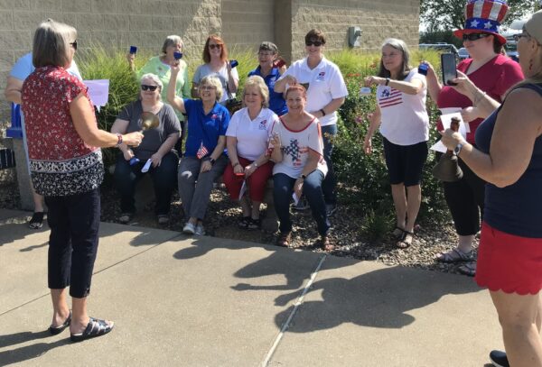 group of ladies ringing handbells outside