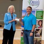 chapter regent presents check to man from Oasis International