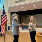 regent with big hat presents patriot of the month award