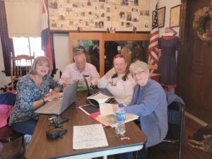 4 people working at a table at the Fenton Historical Society