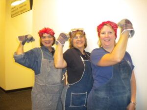 women having fun dressing as Rosie the Riveter