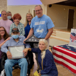 family and friends with honored veteran of the month