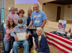 family and friends with honored veteran of the month