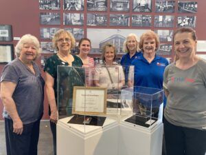 women gathered around a museum display