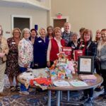 chapter members gathered around baby items for a veterans event