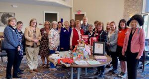 chapter members gathered around baby items for a veterans event